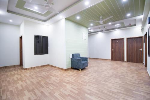 an empty room with a chair and a door at Treebo Royal Imperial, Bikaner Railway Station in Bikaner