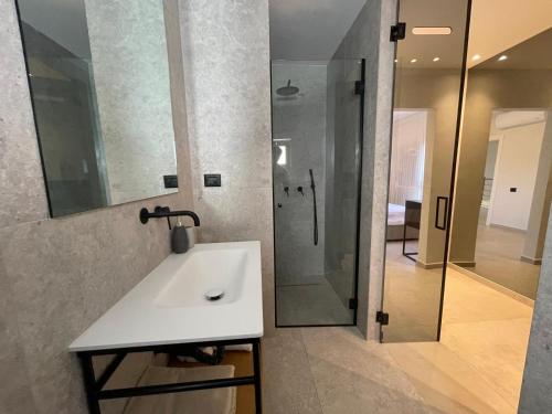 a bathroom with a white sink and a shower at Villa Keshet Eilat in Eilat