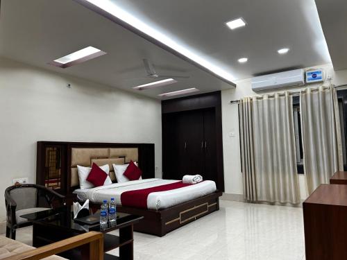 a hotel room with a bed and a table at The Heritage in Dumka
