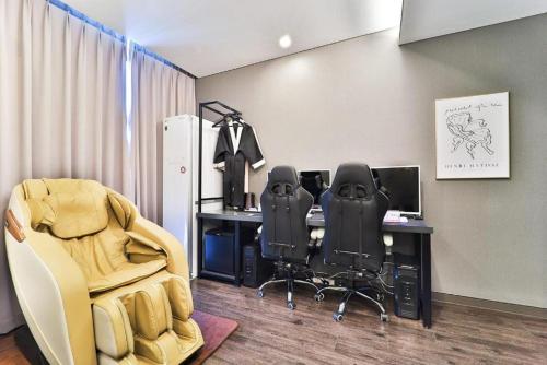 an office with two chairs and a desk with a computer at Zam 101 in Busan