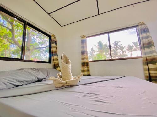a bedroom with a bed with a bird on it at Green Garden Beach Resort, Sipalay in Sipalay