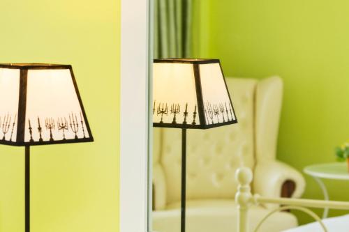 a pair of lamps in a living room with a chair at Takanta Place in Udon Thani