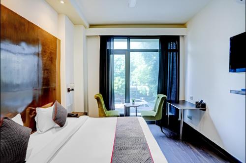 a hotel room with a bed and a window at The Orion - Greater Kailash in New Delhi
