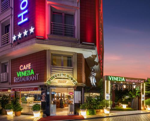 a building with a cafe vaza restaurant on a street at Vicenza Hotel Istanbul Old City in Istanbul