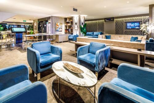 a waiting room with blue chairs and a table at Vicenza Hotel Istanbul Old City in Istanbul