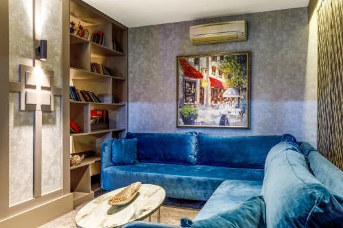 a blue couch in a living room with a table at Vicenza Hotel Istanbul Old City in Istanbul