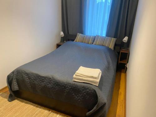 a bedroom with a bed with a towel on it at Apartament Świder in Otwock