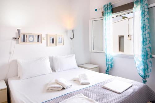 a bedroom with a bed with towels on it at Garden Apartments in Rózia
