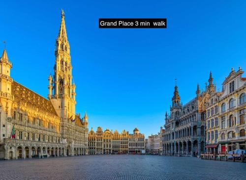 a large building with a clock tower on a street at New Stylish Grand place City Center Duplex in Brussels