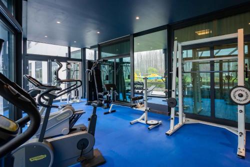 a gym with blue flooring and a large glass wall at ibis Styles Milano Est Settala in Settala