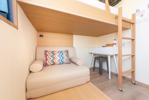 a small room with a bunk bed and a desk at Lemon Hotel - Metro Line 1 Line 7 Changshu Road 200 meters in Shanghai