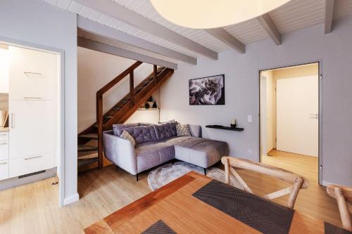 a living room with a couch and a staircase at Karbon in Münster