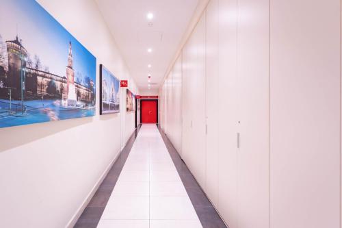 a corridor in a building with a red door at ibis Styles Milano Est Settala in Settala