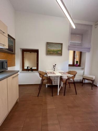 a kitchen and dining room with a table and chairs at Apartmány Zvonárska in Košice