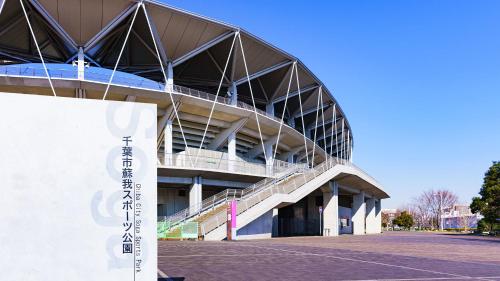 a large building with stairs in front of it at Toyoko Inn Chiba Ekimae in Chiba