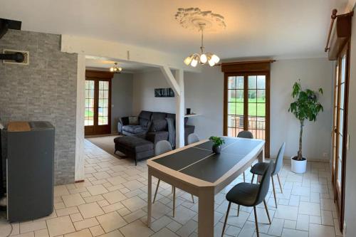 a kitchen and living room with a table and chairs at Maison de campagne proche de Sézanne avec parking in Le Meix-Saint-Époing