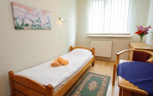 a small bedroom with a bed with towels on it at Ośrodek Wypoczynkowy TVP in Ciechocinek