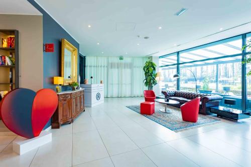 a living room with a couch and a table at ibis Styles Milano Est Settala in Settala