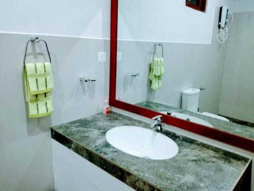 a bathroom with a sink and a mirror at Hideaway Homestay Habarana in Habarana