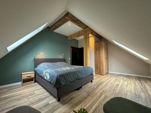 a bedroom with a bed in a attic at De Lindehoeve Appelscha in Appelscha