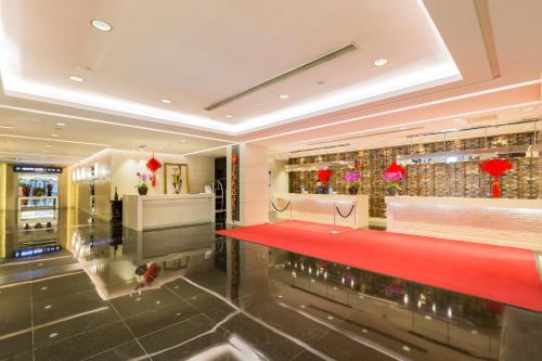 a restaurant with a red counter in a building at Beijing Pudi Hotel in Beijing