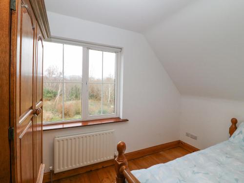a bedroom with a bed and a large window at The Skating Rock in Banane Bridge