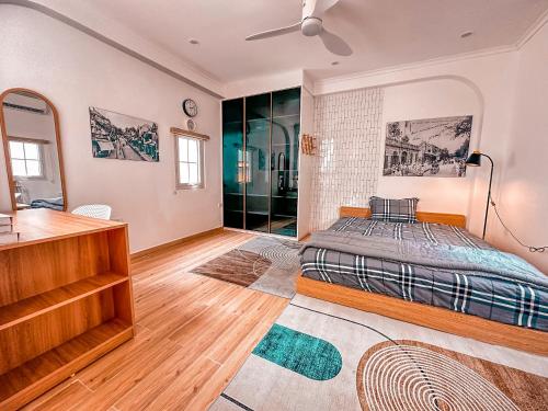 a bedroom with a bed and a dresser in it at La Casa Di Decembre in Hanoi
