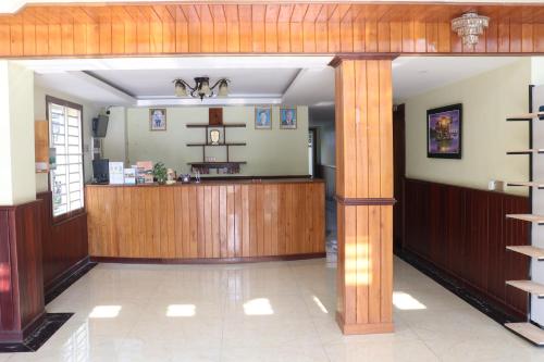a lobby with a counter in the middle of a building at AHHA Boutique Kampot in Kampot