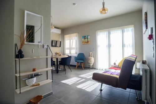 a living room with a bed and a dining room table at Petousis Villas in Galatás
