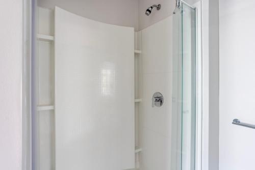 a shower with a glass door in a bathroom at Blueground Brighton gym wd nr T stops BOS-1013 in Boston