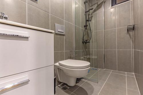a bathroom with a toilet and a shower at NEAR BY THE LAND OF LEGENDs , 40 M2 PRİVATE POOL VİLLA BATİATUS in Belek