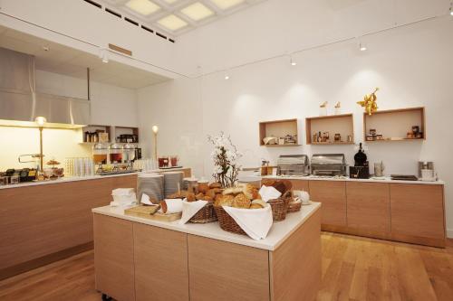 a kitchen with a counter with lots of food on it at Elite Stora Hotellet Linköping in Linköping