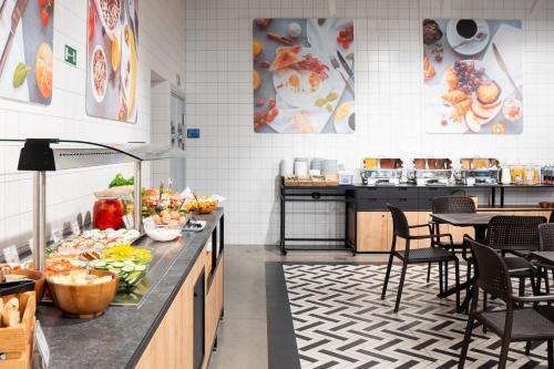 a kitchen with a counter with food on it at Suntago Village - Oficjalny nocleg Suntago in Mszczonów