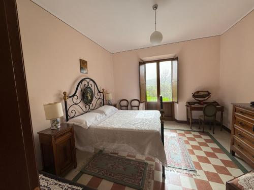 a bedroom with a bed and a dresser and a window at La Casa Del Contadino in Bevagna