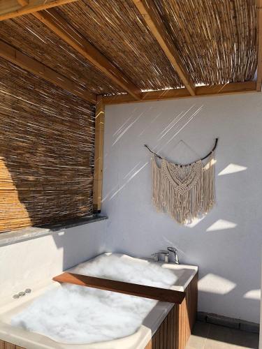a bathroom with a bath tub and a window at MAIA Luxury Beach Hotel & Spa in Guzelcamlı