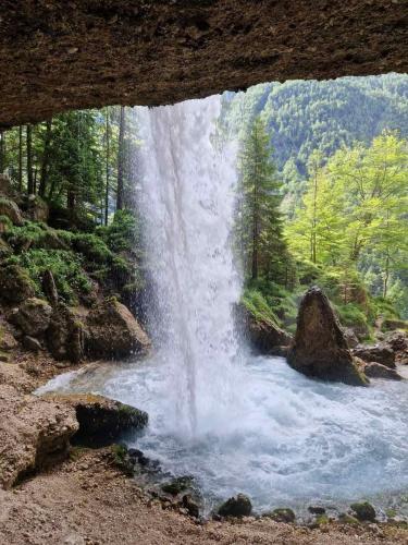 a waterfall in the middle of a river at Apartments Karin in Bled