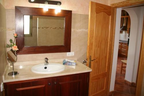 a bathroom with a sink and a mirror at Can Juanito in Cala Llombards