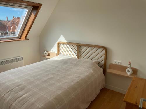 a bedroom with a large bed and a window at Peppino II 0202 - 3 bedrooms 6p - penthouse sunny terraces in Sint-Idesbald