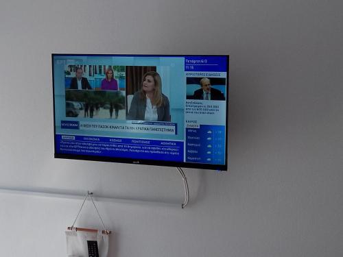 a flat screen tv hanging on a wall at City Apartment Ierapetra 2A in Ierápetra
