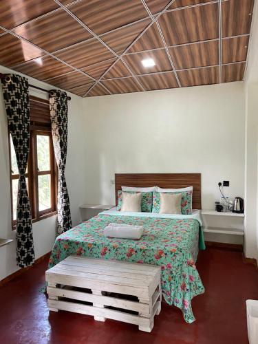 a bedroom with a bed and a wooden ceiling at Mountain vibe ella in Ella