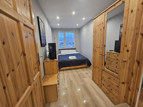 a small bedroom with a bed and a window at City Sense - Apartament z widokiem na góry i miasto in Bielawa