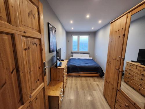a small bedroom with a bed and a window at City Sense - Apartament z widokiem na góry i miasto in Bielawa