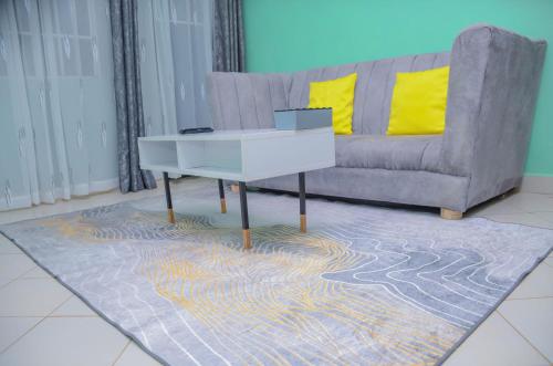 a living room with a couch and a table at Amani Homes in Eldoret