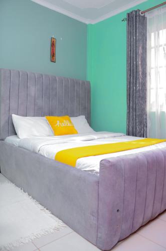 a large bed in a room with blue walls at Amani Homes in Eldoret