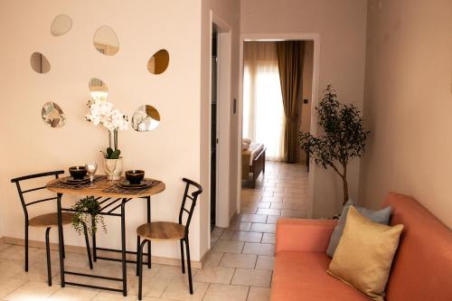 a living room with a table and a couch at Ten Number Suites in Limenas