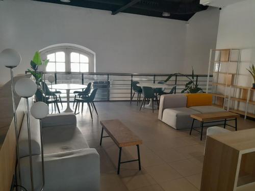 a living room with a couch and a table and chairs at UP Hostel Valencia in Valencia
