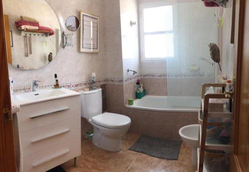 a bathroom with a toilet and a tub and a sink at Apartamentos La Atalaya 188 - 189 in Conil de la Frontera