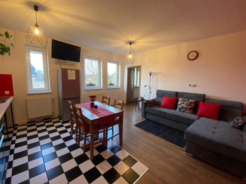 a living room with a couch and a table at Colibri Apartament Lubniewice in Lubniewice