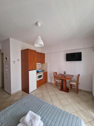 a bedroom with a bed and a kitchen with a table at Porto Xronia in Khronia