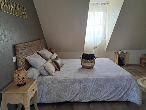 a bedroom with a large bed and a window at La Maison des Poulains in Sauzon